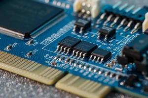 Electronic circuit board close up. Processor, chips and capacitors. photo