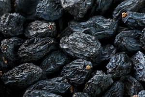 Black Raisin texture, popular dried fruit. Dried grapes. photo