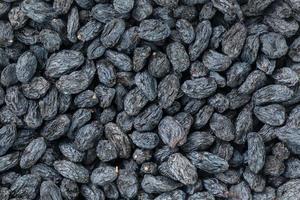 Black Raisin texture, popular dried fruit. Dried grapes. photo