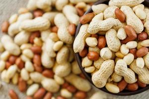 Peanuts in the shell and peeled closeup in a cup photo