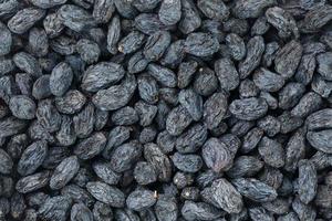 Black Raisin texture, popular dried fruit. Dried grapes. photo