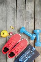 Composition with sport shoes on wooden background photo
