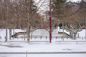 stairs of the city park with snow in winter photo