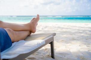 Man relaxing on beach chair at the beach. photo