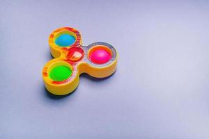 Bright spinner and simple dimple. Fashionable and modern antistress toy for children and adults. photo