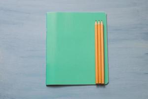 Top view of blank paper with pencils. Pencils on a notebook sheet. Space for text. photo