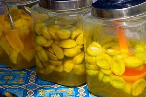 pickles mango and pineapple placed in a jar, selling street vendors photo