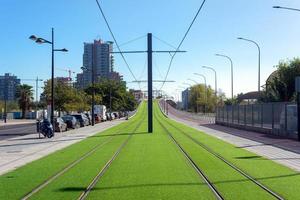 tramway line decorated with artificial grass at a sunny morning photo