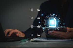Document management system concept, business man holding folder and document icon software, searching and managing files online document database, for efficient archiving and company data. photo