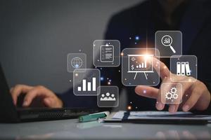 business management concept. development and management Executives looking virtual screens business management icons Goal setting, information, workflows, optimal business operations and innovation photo