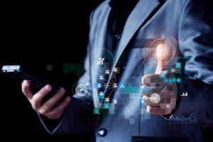 Businessman using mobile smartphone on global network connection on investor and customer with sale data exchange and development of business. Technology and digital marketing. Financial and banking. photo
