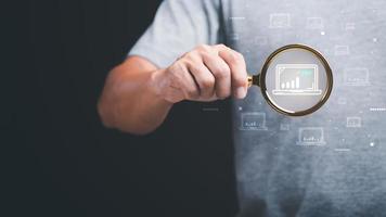 optimization analysis tools, search engine rankings, social media sites based on results analysis data,Marketer holding a magnifying glass showing SEO concepts,Marketing to increase people to website photo