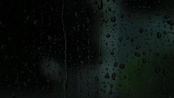 Rain drops on the glass. Small raindrop rests on glass while raining. video