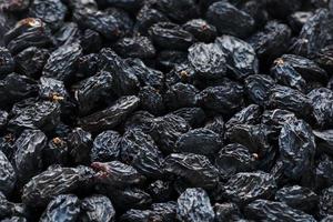 Black Raisin texture, popular dried fruit. Dried grapes. photo