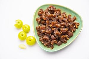 digestive dried amla candy with fresh Indian gooseberry photo