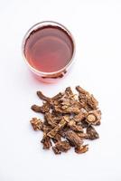 Raw dried Indian Ayurvedic Sarsaparilla, anantmool with Kadha drink or Tea photo