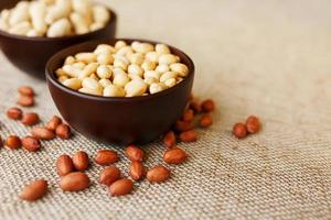 Peanuts in the shell and peeled closeup in a cup photo