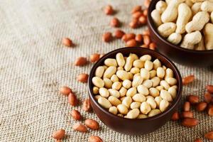 Peanuts in the shell and peeled closeup in a cup photo