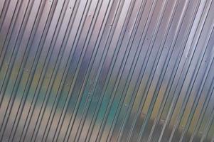 Silver tin iron wall with vertical and diagonal stripes from a metal profile of a metal sheet. Texture, background photo