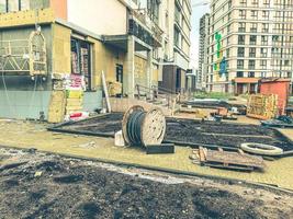 construcción de un nuevo barrio en la ciudad. construcción de casas altas de varios pisos a partir de bloques de hormigón. construcción de macizos de flores, senderos, creación de infraestructura foto