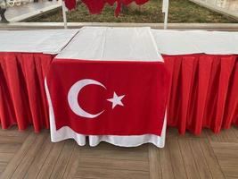 A table decorated with a Turkish flag in a restaurant cafe bar a catering establishment for relaxation in a hotel in a warm tropical eastern country southern resort photo