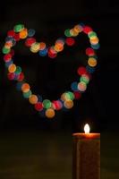Candles light with bokeh like heart. Abstract candle background. photo