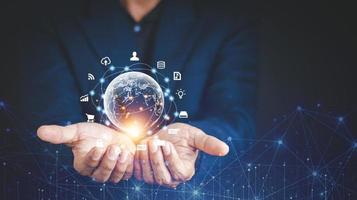 Hand holding virtual Global Internet connection metaverse. Business global internet connection application technology and digital marketing, Financial and banking, Digital link tech, big data. photo