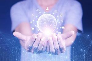 Hand holding virtual Global Internet connection metaverse. Business global internet connection application technology and digital marketing, Financial and banking, Digital link tech, big data. photo