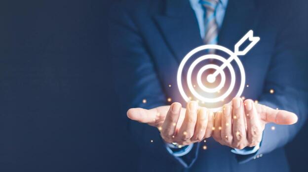 Businessman holding virtual dartboard and arrow with copy space for setup business objective target concept. photo