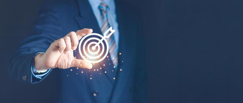 Businessman holding virtual dartboard and arrow with copy space for setup business objective target concept. photo