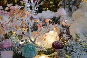 Christmas decorations for the shopping center. decor from artificial branches of spruce and other trees, a Christmas wreath. cute birds made of artificial materials lie in the nest photo