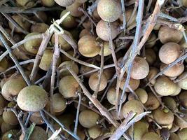 Longan, Dimocarpus longan, fruit from Asia, the same family of lychee. This fruit is often found in traditional and modern fruit markets photo