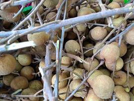 Longan, Dimocarpus longan, fruit from Asia, the same family of lychee. This fruit is often found in traditional and modern fruit markets photo