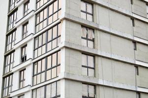 Windows and accessories of a new modern monolithic frame-block house under construction with windows, walls and balconies. Background, texture photo