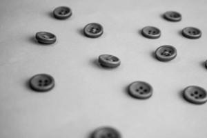 Beautiful black and white texture with a lot of round buttons for sewing, needlework. Copy space. Flat lay. the background photo