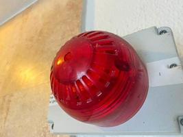 Large red plastic industrial fire alarm siren warning light for accident and disaster prevention and evacuation photo