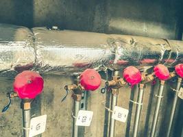 counters for the supply of energy resources to the apartment. on the meters, the valves cut off the water supply to the apartments. counters hang on a foil pipe photo