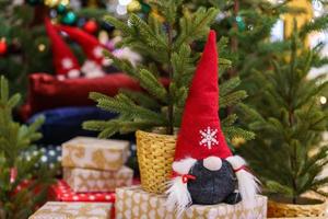 Little santa claus toy, close up. Traditional doll for christmas under the tree. photo