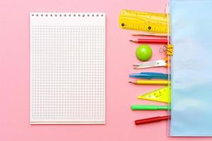 School notebook and various office supplies. Back to school concept photo