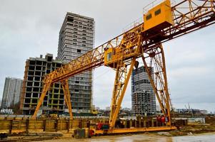 A construction site with specialized professional equipment and cranes during the construction of a modern line of the underground metro station in the big city of the metropolis