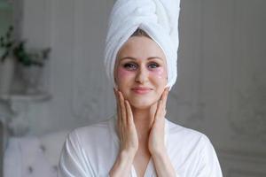 Head shot Smiling attractive female caucasian woman applying hydrogel head photo