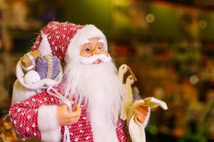 Close-up of santa claus doll, santa claus statue with christmas decorations photo