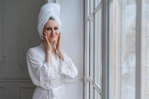 Portrait gorgeous young woman wearing white silk robe and turban towel on her
