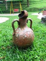 broken jug with green grass background photo