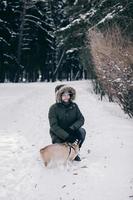 man in a jacket walks with a dog photo