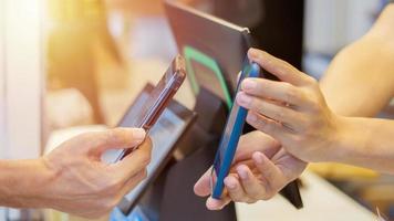 Close up man uses mobile phone to scan QR code for payment photo