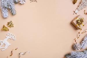 Christmas flat lay composition with gifts, cones, pine on beige background top view. Copy space. photo