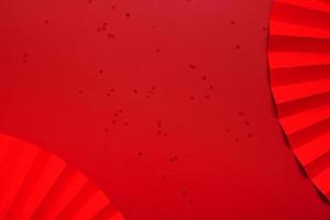 Red paper fan and stars.  Monochrome new year  background top view with copy space photo