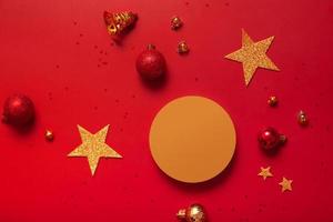 Mock up podium or pedestal for skincare beauty products and Christmas decorations top view on red background photo