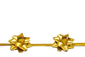 Two golden gift bows with a ribbon on a white background with copy space. isolated object. Universal template for postcards, posters, banners photo